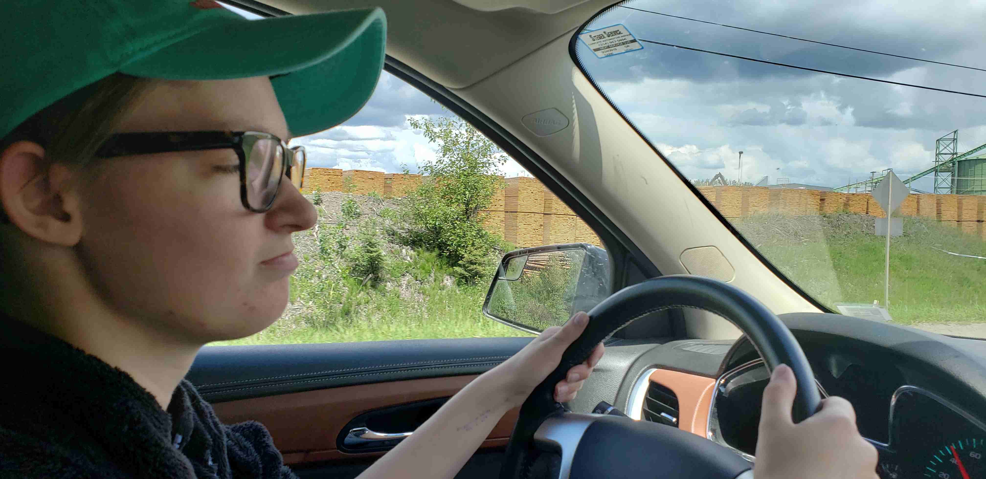 2019-06-25 Cate driving past lumberyard